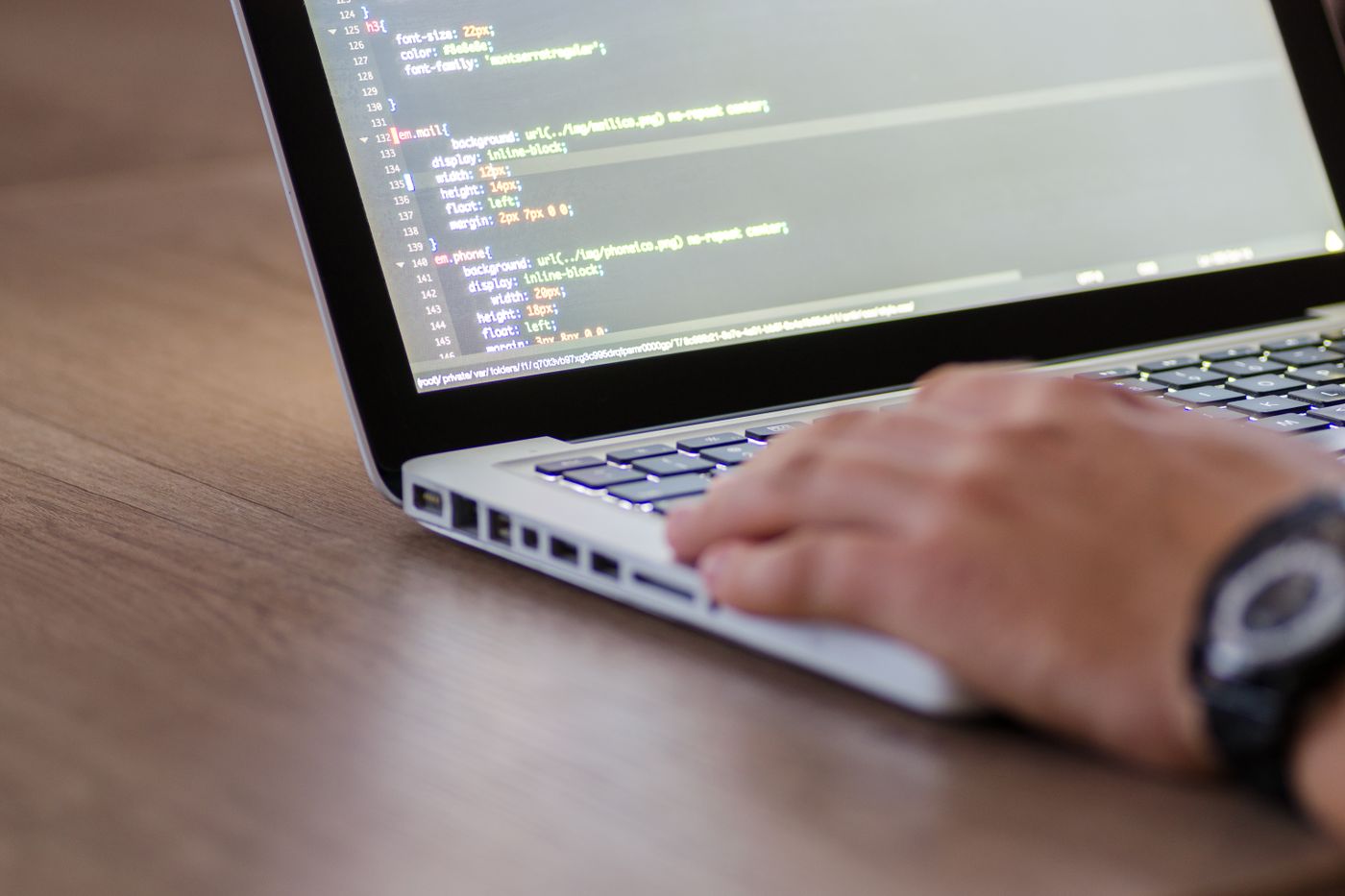 Dizüstü bilgisayarda kod yazan eller – CS-Cart Özel Eklenti ve Modül Geliştirme